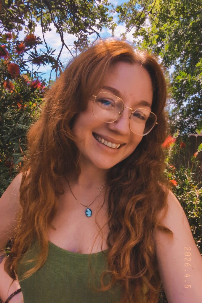 Rea, smiling outdoors in her garden