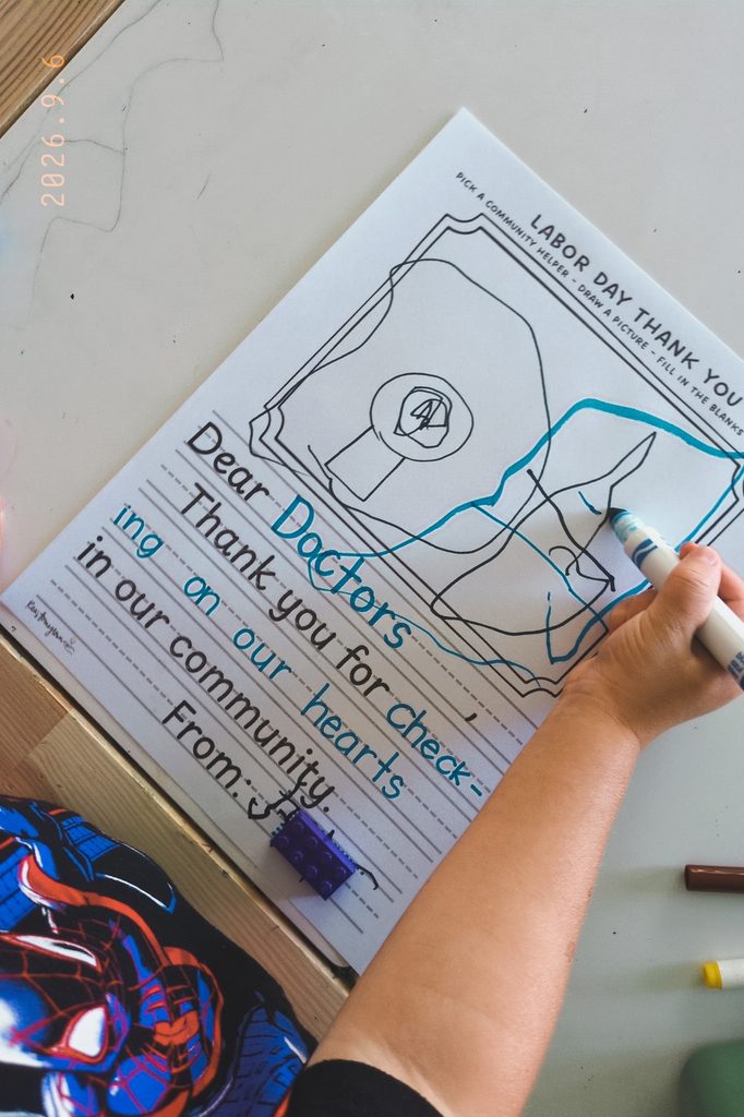 Little boy doing the thank you card for a doctor